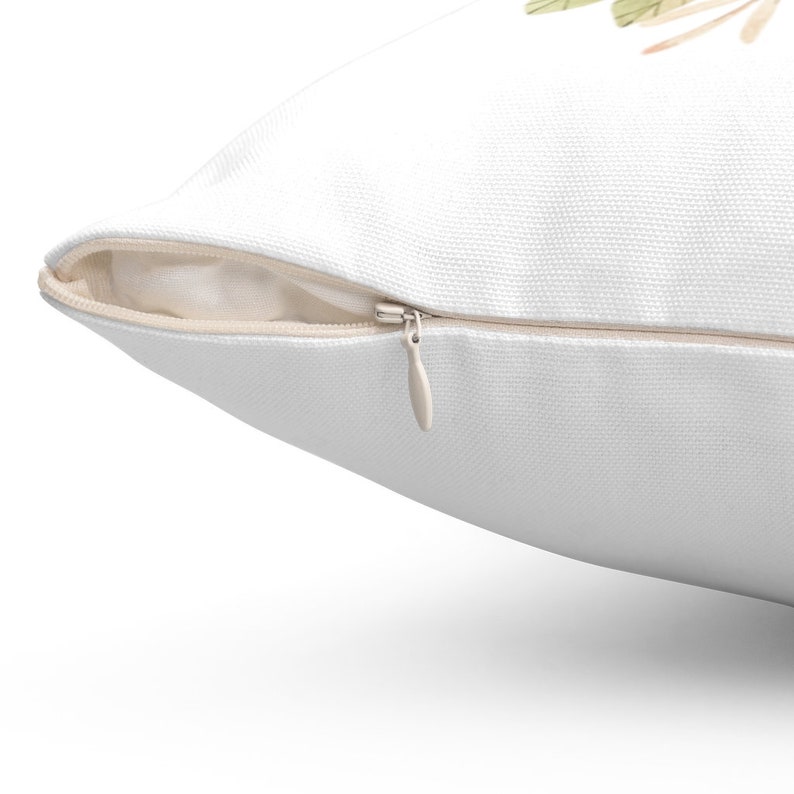 May include: White pillow cover with a zipper closure. The zipper is visible and is open.
