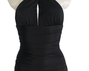 May include: A black halter-style swimsuit with a keyhole cutout at the neckline and a ruched design on the bodice and skirt.