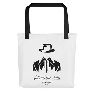 May include: White tote bag with black handles and a black silhouette of a person wearing a hat and suit. The text "follow the data" is written in cursive below the silhouette. The text "STEM GANG est. 2023" is written in all caps below the cursive text.