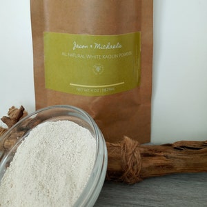 May include: A brown paper bag with a white label that reads "Jason & Michaels All Natural White Kaolin Powder" and "Net Wt 4 oz | 118.29mL". A white powder is in a clear glass bowl.