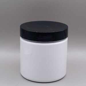 May include: A white plastic jar with a black lid. The jar is empty and ready to be filled with your favourite product.
