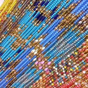 May include: A collection of colorful beaded strands, including blue, yellow, red, and gold. The strands are arranged in a diagonal pattern, creating a visually appealing and textured design.