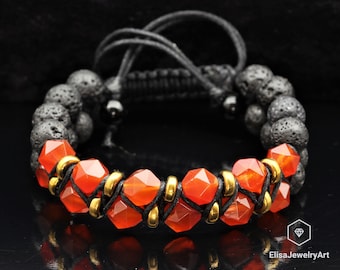 May include: A bracelet with orange carnelian beads, gold spacers, and black lava rock beads. The bracelet is tied with black cord.