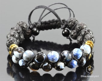 May include: A black cord bracelet with black lava rock beads, blue agate beads, and gold spacers. The bracelet is tied with a macrame knot.