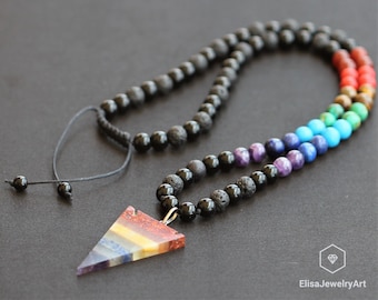 May include: A black lava rock beaded necklace with a triangular pendant made of seven chakra stones. The pendant is a layered triangle with each layer a different color, representing the seven chakras.