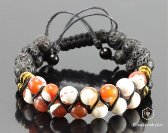 May include: A black cord bracelet with brown and white agate beads and black lava rock beads. Gold spacers are interspersed between the beads.