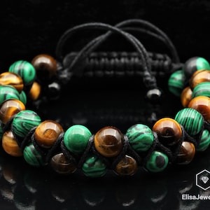 May include: A braided black cord bracelet with alternating tiger's eye and malachite beads.