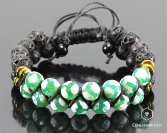 May include: A black cord bracelet with green and white agate beads and black lava rock beads. The bracelet has gold accents.