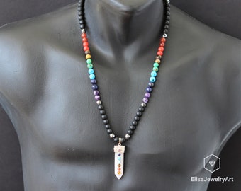 May include: A black onyx beaded necklace with a white quartz pendant featuring seven chakra stones. The stones are arranged in a rainbow pattern, representing the seven chakras.