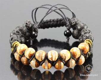 May include: A black cord bracelet with brown and white agate beads and black lava rock beads. The bracelet has gold metal spacers.