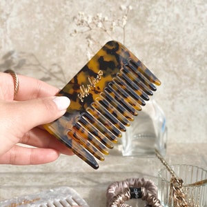 May include: A tortoiseshell comb with the words "silkenlove" printed in gold lettering.