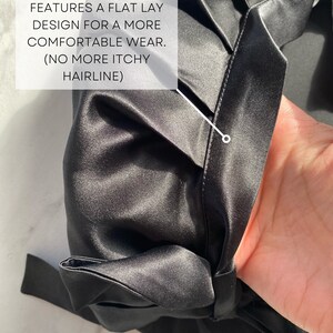 May include: Close-up of a black satin garment. The fabric has a subtle sheen and is gathered at the seams. Text on the image reads: "FEATURES A FLAT LAY DESIGN FOR A MORE COMFORTABLE WEAR. (NO MORE ITCHY HAIRLINE)". The brand name "silknlove co." is also visible.