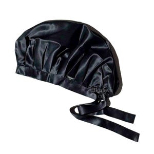 May include: Black satin sleep cap with a gathered top and two long ties. The cap has a small label that says "silklove co."