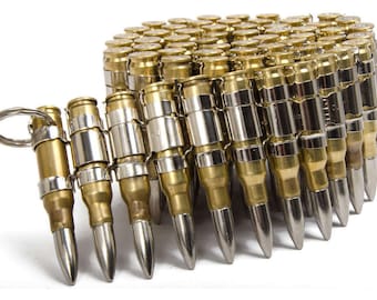 May include: A silver and brass bullet belt with a key ring attached. The belt is made up of a series of linked bullets, each with a silver tip.