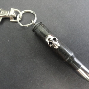 Key chain with real .308 caliber bullet and skull head stud