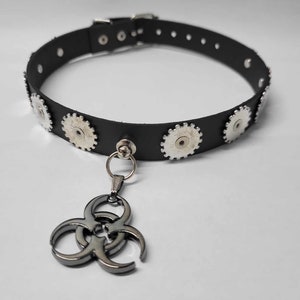May include: Black leather choker with silver gear-shaped accents and a biohazard symbol pendant.
