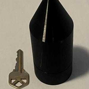 May include: A white ceramic mug with a black handle and the text "But first, coffee" in a handwritten style. The mug is on a white surface. The mug is 4 inches tall.