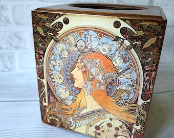 May include: A wooden tissue box cover with a colorful Art Nouveau design featuring a woman with flowing hair and a crown of flowers. The design includes a circle of zodiac symbols.
