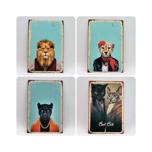 May include: Four vintage-style metal signs featuring animal portraits. The top left sign shows a lion with a blue background. The top right sign shows a cheetah wearing a red bandana with a blue background. The bottom left sign shows a black panther with a blue background. The bottom right sign shows two black cats with a blue background and the text "Cool Cats".