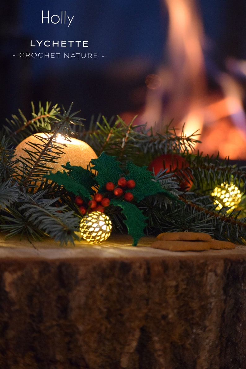 May include: A close-up of a crocheted holly sprig with red berries, surrounded by evergreen branches and lit with small, golden lights. The text "Holly Lychette - Crochet Nature -" is visible above the sprig.