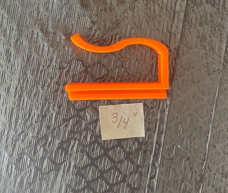 May include: Orange plastic 3/4 inch hook for hanging items.