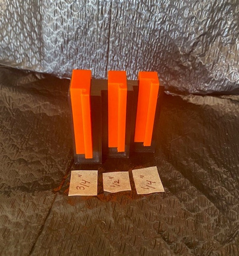 May include: Four orange acrylic blocks of varying heights, labeled with fractions: 3/4, 1/2, 1/4. The blocks are arranged from tallest to shortest.