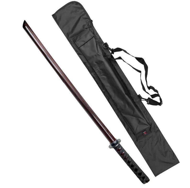 May include: A black sword scabbard with a shoulder strap and a wooden katana sword with a black handle and a black and red wrapped grip.