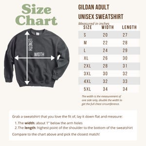 May include: A size chart for a Gildan adult unisex sweatshirt. The chart shows measurements in inches for sizes S to 5XL. The width is measured one inch below the arm holes, and the length is measured from the shoulder to the bottom of the sweatshirt.