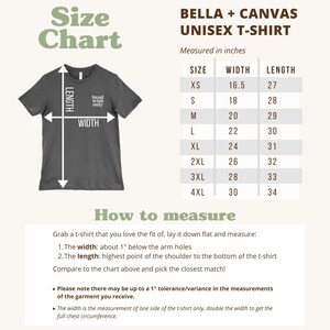 May include: A dark gray Bella + Canvas unisex t-shirt size chart with instructions on how to measure. The chart lists sizes XS through 4XL with corresponding width and length measurements in inches. Text includes 'Size Chart', 'How to measure', and instructions.