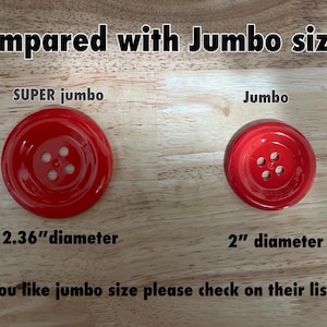 May include: Two red buttons, one labeled "SUPER jumbo" and measuring 2.36 inches in diameter, and the other labeled "Jumbo" and measuring 2 inches in diameter. The text "Compared with Jumbo size" is at the top of the image.