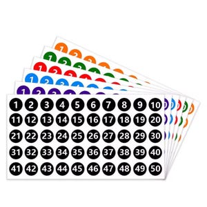May include: A set of number stickers, featuring numbers 1-50 in black circles on white backgrounds. The top row has numbers 1 and 2 in various colors. Ideal for labeling, organizing, or crafting projects.