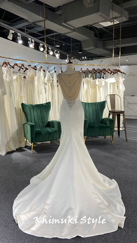 back beaded wedding dress NEW ARRIVAL- EVANGELINE This Sheath wedding dress has a scoop neckline,  illusion, side cutouts, and low back in beaded Chantilly lace