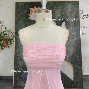 May include: A light pink strapless dress on a mannequin. The bodice features horizontal ruching and embroidered floral details. The skirt is a flowing, sheer fabric. The text "4Khimuki Style" is visible on the dress.