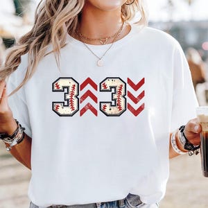 Baseball graphic shirt featuring the phrase 3 Up 3 Down displayed in bold distressed numbers with directional arrow accents; athletic-inspired typography arranged in a centered layout that reflects classic baseball scoreboard style; clean sports design created for fans players and game day wear