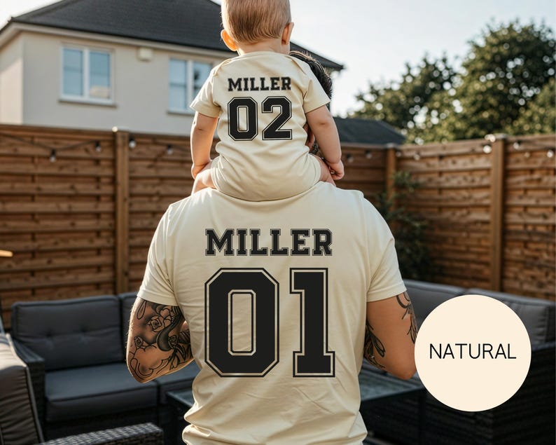 May include: Matching beige t-shirts with black lettering and numbers. The adult shirt reads "MILLER 01", while the child's shirt says "MILLER 02". The shirts are a light beige color, with a "NATURAL" circle in the bottom right corner.