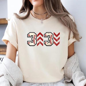 Baseball graphic shirt featuring the phrase 3 Up 3 Down displayed in bold distressed numbers with directional arrow accents; athletic-inspired typography arranged in a centered layout that reflects classic baseball scoreboard style; clean sports design created for fans players and game day wear