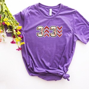 Baseball graphic shirt featuring the phrase 3 Up 3 Down displayed in bold distressed numbers with directional arrow accents; athletic-inspired typography arranged in a centered layout that reflects classic baseball scoreboard style; clean sports design created for fans players and game day wear