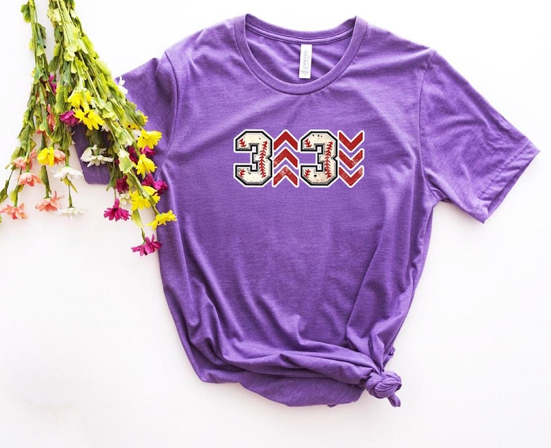 Baseball graphic shirt featuring the phrase 3 Up 3 Down displayed in bold distressed numbers with directional arrow accents; athletic-inspired typography arranged in a centered layout that reflects classic baseball scoreboard style; clean sports design created for fans players and game day wear