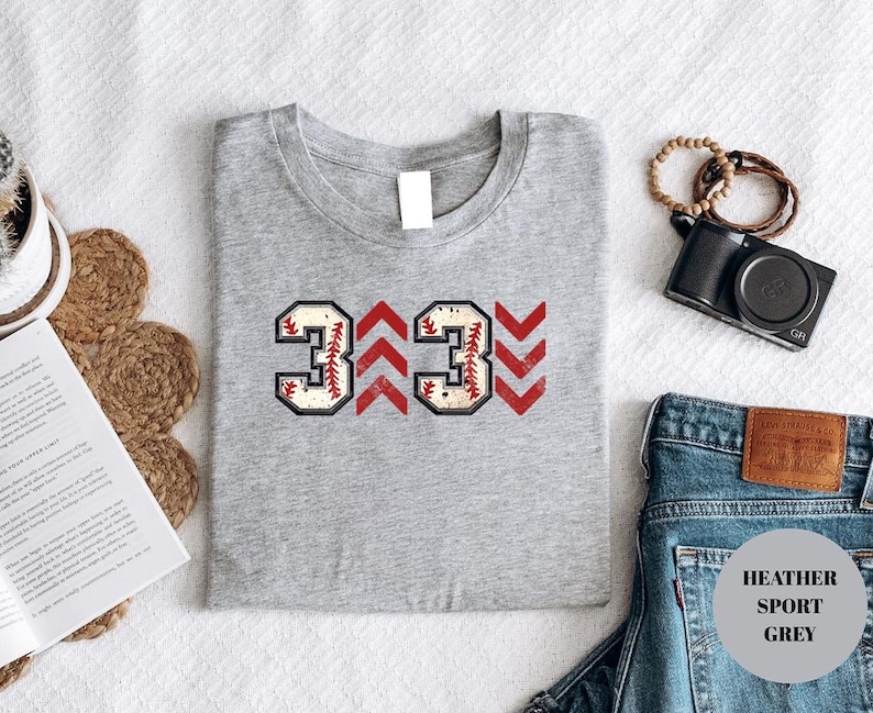 Baseball graphic shirt featuring the phrase 3 Up 3 Down displayed in bold distressed numbers with directional arrow accents; athletic-inspired typography arranged in a centered layout that reflects classic baseball scoreboard style; clean sports design created for fans players and game day wear