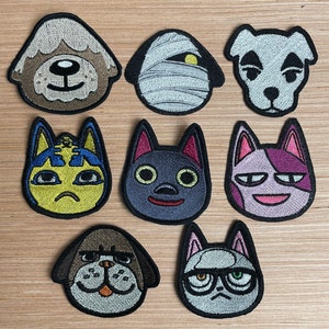 May include: Nine embroidered patches featuring various animal characters. The patches are colorful and feature different designs, including a dog, a cat, a wolf, a bear, and a fox.