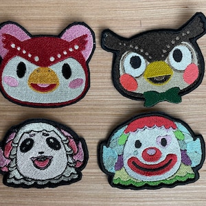 May include: Four embroidered patches featuring animal characters. The patches are in various colors, including red, white, black, green, and yellow. The characters include an owl, a sheep, a bird, and a clown.
