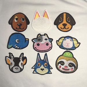 May include: Nine embroidered patches featuring various animal faces. The patches include a dog, cat, cow, sheep, deer, wolf, and sloth. Each patch has a detailed design with different colors and outlines, perfect for decorating clothing or accessories.