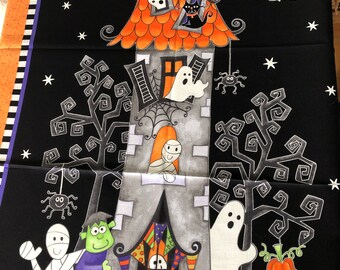 May include: A black fabric panel with a Halloween theme. A spooky house with orange roof and gray walls is surrounded by trees and pumpkins. There are ghosts, bats, spiders, and a black cat in the image.
