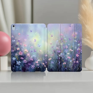 May include: An open tablet case featuring a floral design with pink, purple, and white flowers, and butterflies against a soft, pastel background. The case is designed to protect the tablet and adds a touch of artistic flair.