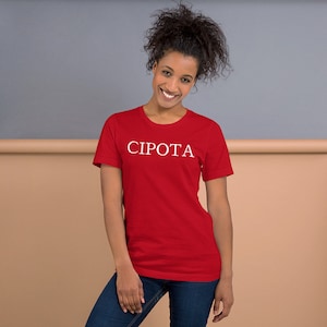 May include: A red t-shirt with the word "CIPOTA" printed in white on the front.