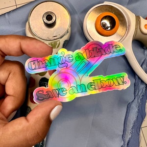 Holographic Sewing Vinyl Sticker - Change a Blade Save an Elbow