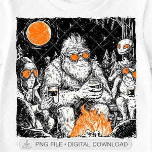 May include: White t-shirt featuring a black and white graphic of a Bigfoot, an alien, and another alien-like creature around a campfire. All three are wearing sunglasses and holding mugs. The background includes a night sky, trees, and a full orange moon.