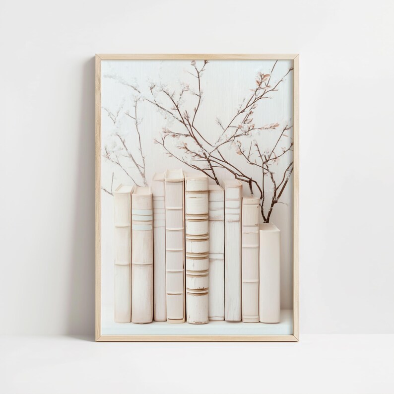 May include: A framed print of a white background with a row of white books and a delicate floral design in shades of brown and white.