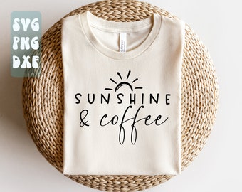 May include: A white t-shirt with a black graphic design of a sun and the text "Sunshine & coffee".