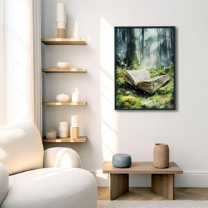 May include: A framed watercolor painting of an open book lying on a bed of moss in a misty forest. The book is open to a blank page, and the forest is filled with tall trees and green foliage.